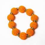 Handcrafted beaded ball bracelet featuring vibrant orange beads and gold-toned accents, elegantly designed for a stylish and unique look.