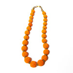 Handcrafted beaded ball necklace featuring vibrant orange beads and gold-toned accents, elegantly designed for a stylish and unique look.