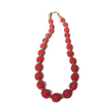 Handcrafted beaded ball necklace featuring vibrant red beads and gold-toned accents, elegantly designed for a stylish and unique look.